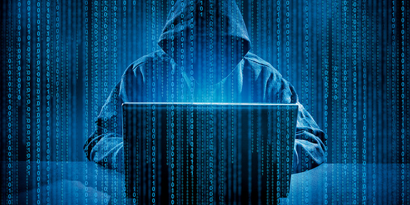 KI generiert: Das Bild zeigt eine Person in einem Kapuzenpullover, die vor einem Laptop sitzt, umgeben von digitalen Binärzahlen. Es vermittelt den Eindruck von Cyberkriminalität oder Hacking.